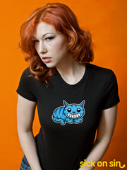 A model wearing a black women tee featuring a grinning blue Cheshire Cat. A cute original design by Sick On Sin