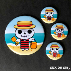 An original design of a cute skeleton wearing a striped bathing suit on a beach. Available on pins, magnets, keychains, etc. from Sick On Sin.