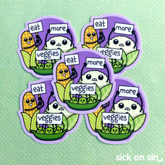 A group of die cut stickers with sweet illustration of corn, cauliflower and peas holding up signs that say 'eat more veggies'. A cute original design by Sick On Sin.