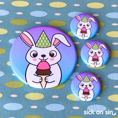 An illustration of a chubby bunny rabbit wearing a party hat and eating a double scoop ice cream cone. An original design by Sick On Sin available on pins, magnets, keychains, etc.