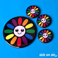 An original illustration of a smiling daiy flower with rainbow coloured petals. This cute design by Sick On Sin is availabe on handpressed flair including pins, magnets and keychains.