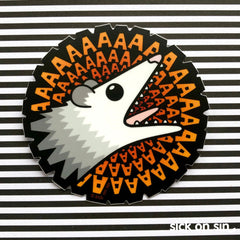 A super fun vinyl sticker featuring an original illustration of a screaming possum with a spiral of AAAA around him. An original design by Sick On Sin.