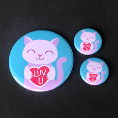 An original design of a smiling purple cat holding a red valentine heart with the text 'Luv U' in white. A cute design by Sick On Sin available on pins, magnets, keychains, etc.