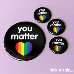 An original illustration of the slogan 'You Matter' with a rainbow heart. This cute design by Sick On Sin is availabe on handpressed flair including pins, magnets and keychains.