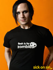 A model wearing a black tshirt with the slogan Flesh Is For Zombies. An original fun vegan design by Sick On Sin.